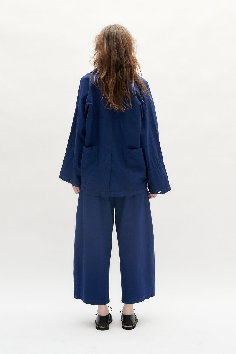 Trousers in dyed cotton from WRIGHT + DOYLE. Thie trousers have deep front pleates that creates a sculpural silhouette. Shown with the Bouy Jacket.