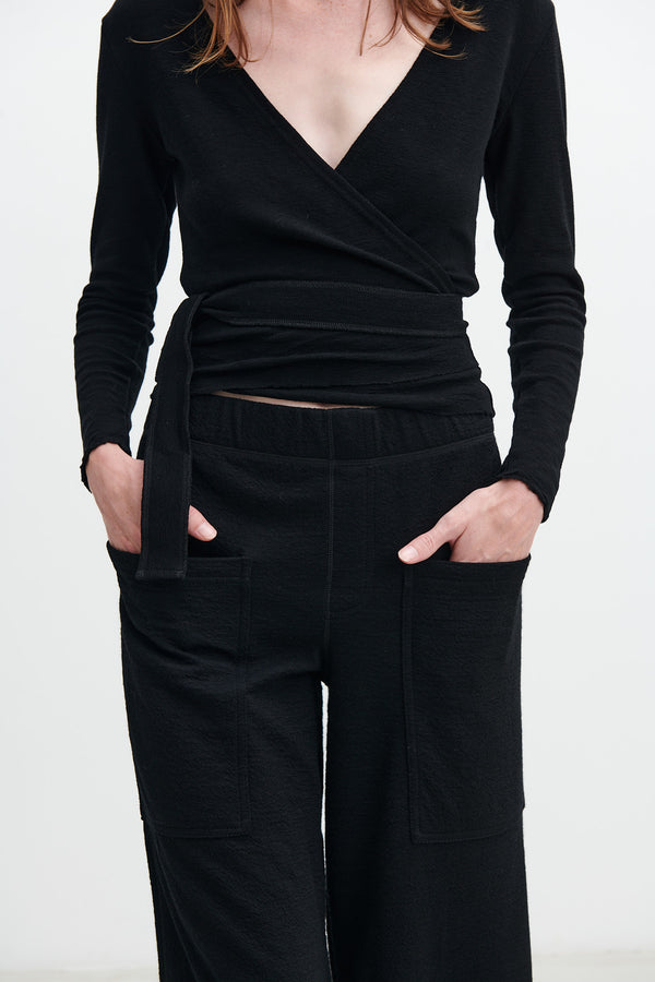 Wrap top in merino wool. By Basics in black.